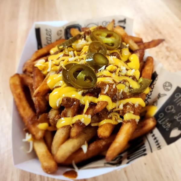 Surf Dawgs Grill chili cheese fries topped with jalapeños, shredded cheese, and cheese sauce.